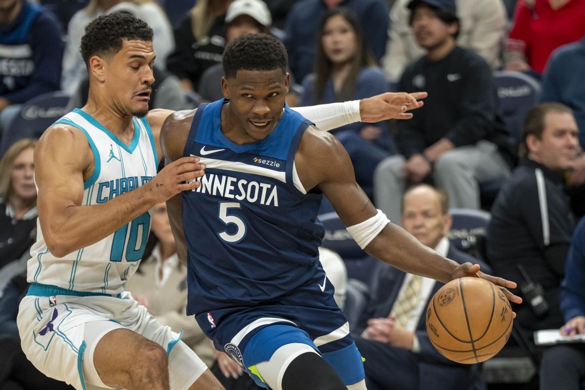 Nov 4, 2024; Minneapolis, Minnesota, USA;  Minnesota Timberwolves guard Anthony Edwards (5) drives to the basket past Charlotte Hornets guard Josh Green (10) in the first half at Target Center. Mandatory Credit: Jesse Johnson-Imagn Images