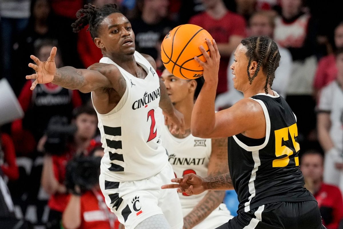 Nov 4, 2024; Cincinnati, OH, USA; Cincinnati Bearcats guard Jizzle James (2) guards Arkansas-Pine Bluff Golden Lions guard Caleb Jones (55) in the second half of the NCAA mens basketball game between the Cincinnati Bearcats and the Arkansas-Pine Bluff Golden Lions at Fifth Third Arena on the University of Cincinnati campus on Monday, Nov. 4, 2024. The Bearcats won 109-54. Mandatory Credit: Sam Greene/USA TODAY Network via Imagn Images