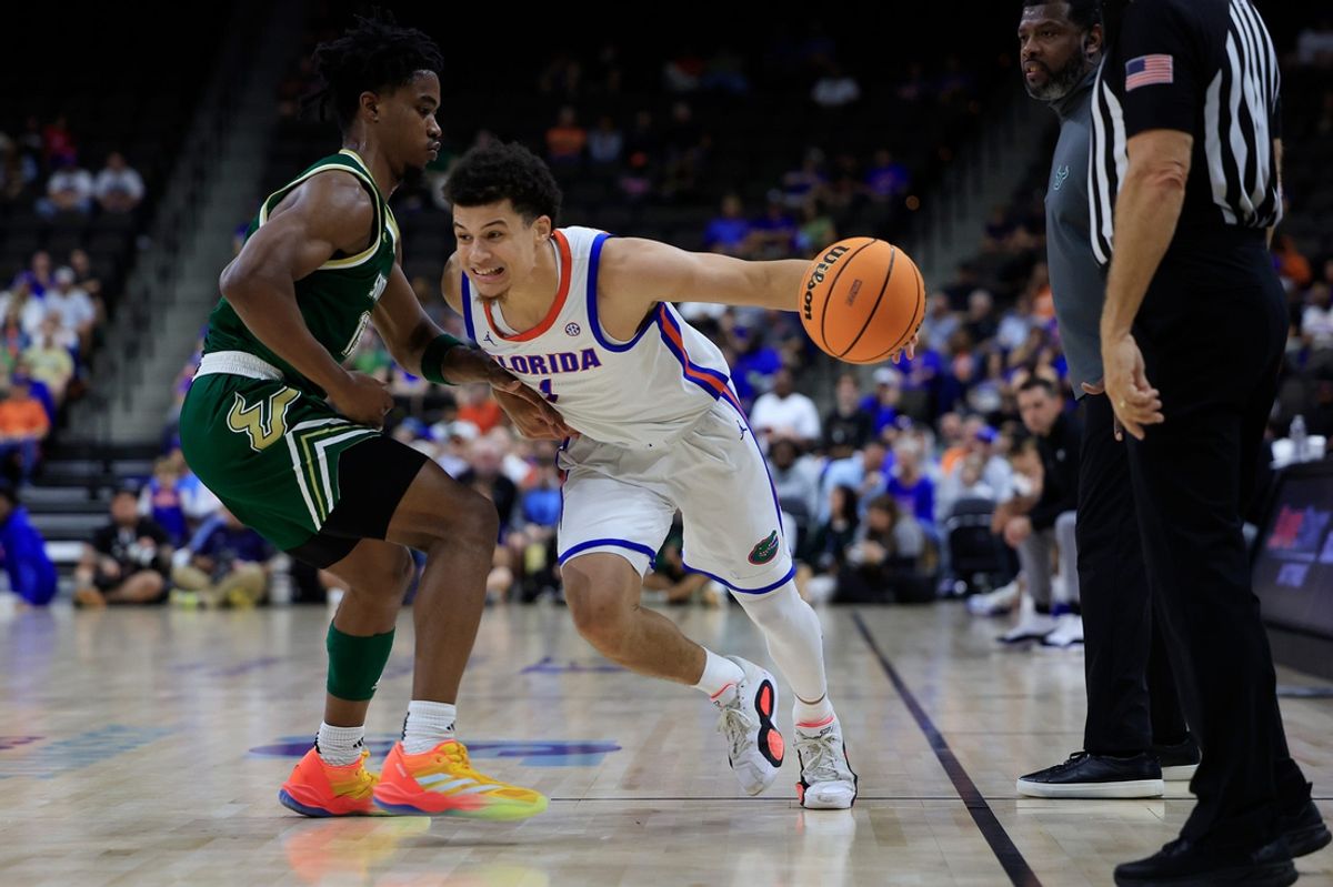 Florida Gators guard Walter Clayton Jr. (1) penetrates against South Florida Bulls guard Kasen Jennings (13) during the first half of an NCAA men’s basketball matchup Monday, Nov. 4, 2024 at VyStar Veterans Memorial Arena in Jacksonville, Fla. [Corey Perrine/Florida Times-Union]