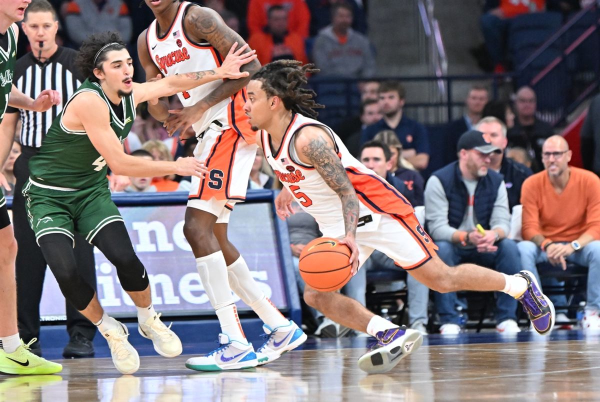 Nov 4, 2024; Syracuse, New York, USA; Syracuse Orange guard Jaquan Carlos (5) tries to drive the ball past Le Moyne Dolphins guard Zek Tekin (4) in the second half at the JMA Wireless Dome. Mandatory Credit: Mark Konezny-Imagn Images