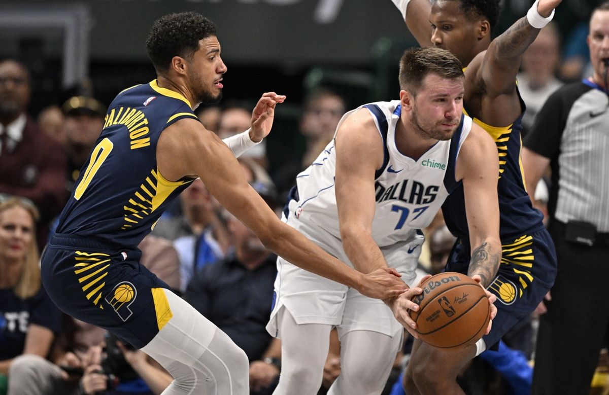 Nov 4, 2024; Dallas, Texas, USA; Dallas Mavericks guard Luka Doncic (77) is fouled by Indiana Pacers guard Tyrese Haliburton (0) during the first quarter at the American Airlines Center. Mandatory Credit: Jerome Miron-Imagn Images