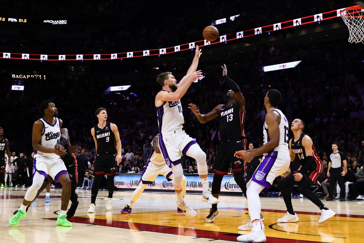 Nov 4, 2024; Miami, Florida, USA; Sacramento Kings forward Domantas Sabonis (11) shoots the game-winning basket over Miami Heat center Bam Adebayo (13) during the fourth quarter at Kaseya Center. Mandatory Credit: Sam Navarro-Imagn Images