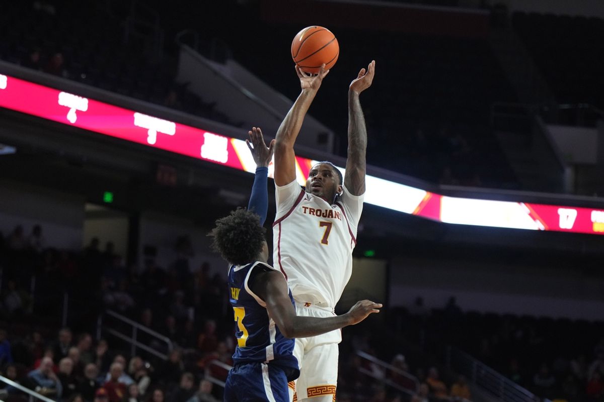 Nov 4, 2024; Los Angeles, California, USA; Southern California Trojans guard Chibuzo Agbo (7) shoots the ball against Chattanooga Mocs guard Honor Huff (3) in the first half at Galen Center. Mandatory Credit: Kirby Lee-Imagn Images