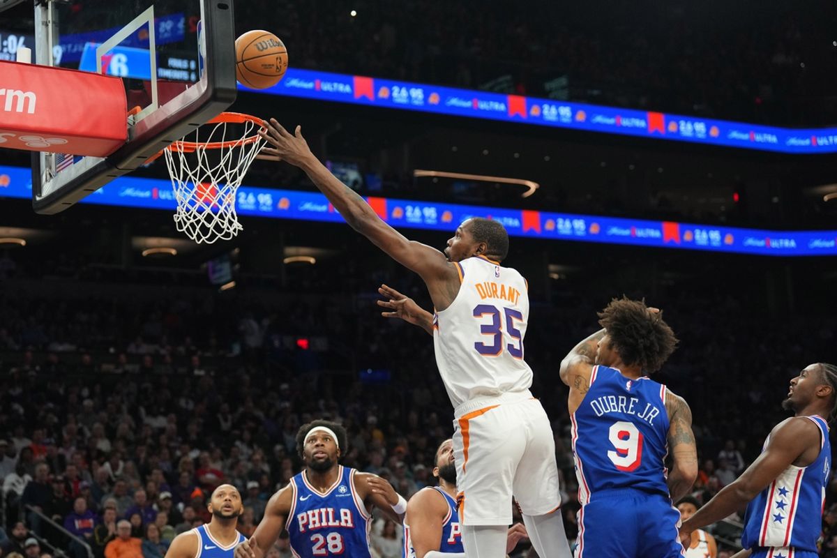 Nov 4, 2024; Phoenix, Arizona, USA; Phoenix Suns forward Kevin Durant (35) puts up a layup over Philadelphia 76ers guard Kelly Oubre Jr. (9) during the first half at Footprint Center. Mandatory Credit: Joe Camporeale-Imagn Images