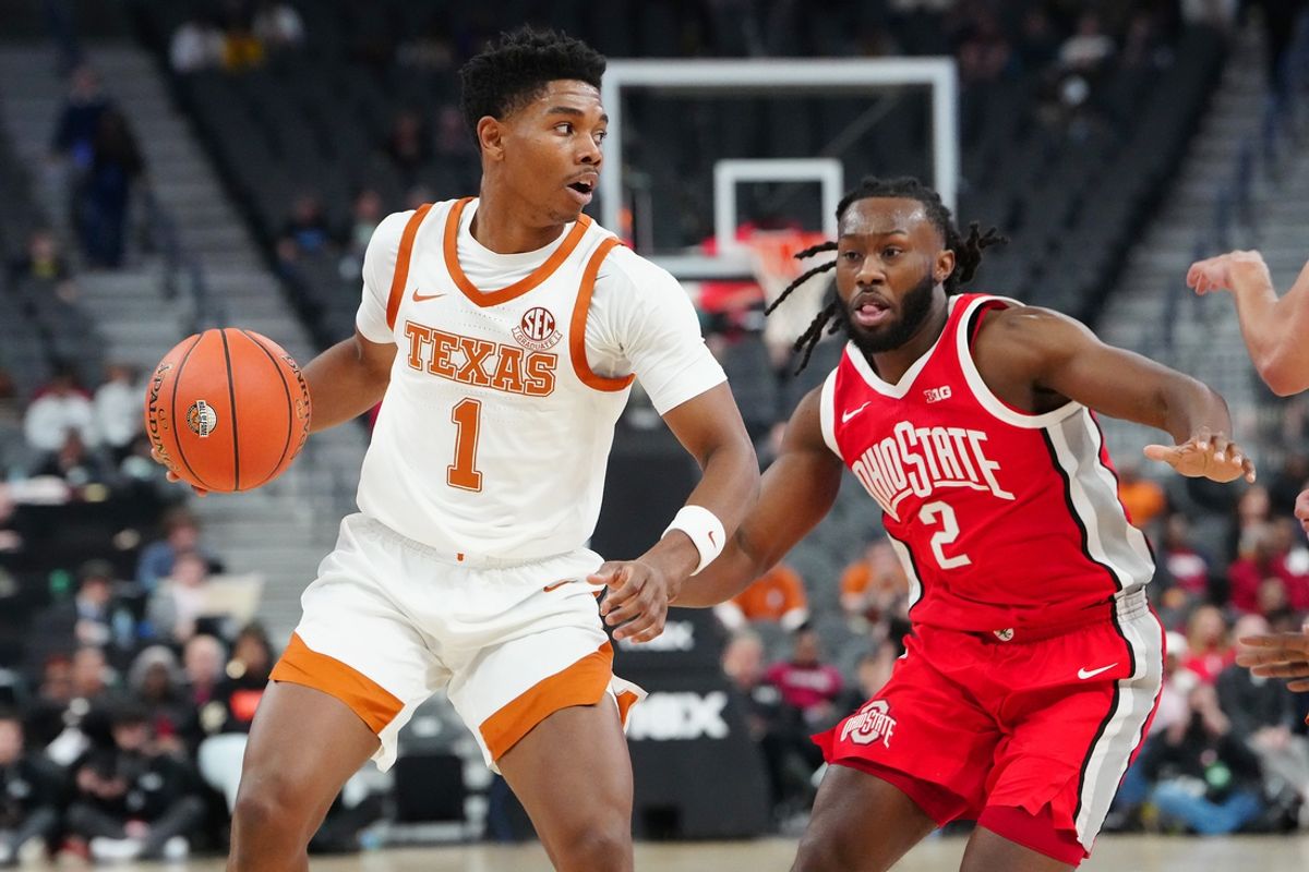 Nov 4, 2024; Las Vegas, Nevada, USA; Texas Longhorns guard Julian Larry (1) dribbles against Ohio State Buckeyes guard Bruce Thornton (2) during the first half at T-Mobile Arena. Mandatory Credit: Stephen R. Sylvanie-Imagn Images
