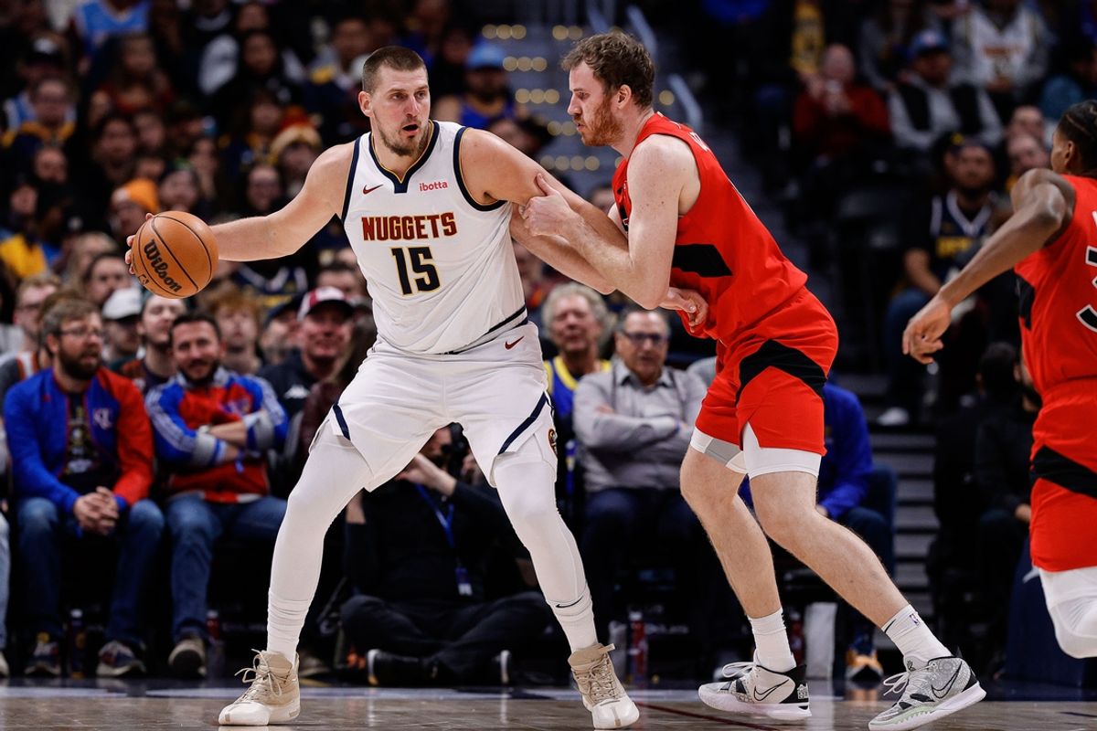 Nov 4, 2024; Denver, Colorado, USA; Denver Nuggets center Nikola Jokic (15) controls the ball as Toronto Raptors center Jakob Poeltl (19) guards in the second quarter at Ball Arena. Mandatory Credit: Isaiah J. Downing-Imagn Images