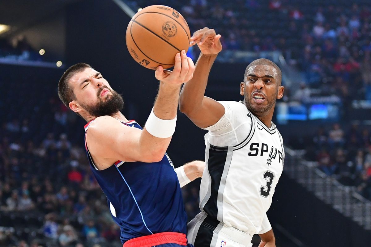 Nov 4, 2024; Inglewood, California, USA; San Antonio Spurs guard Chris Paul (3) plays for the ball against Los Angeles Clippers center Ivica Zubac (40) during the first half at Intuit Dome. Mandatory Credit: Gary A. Vasquez-Imagn Images