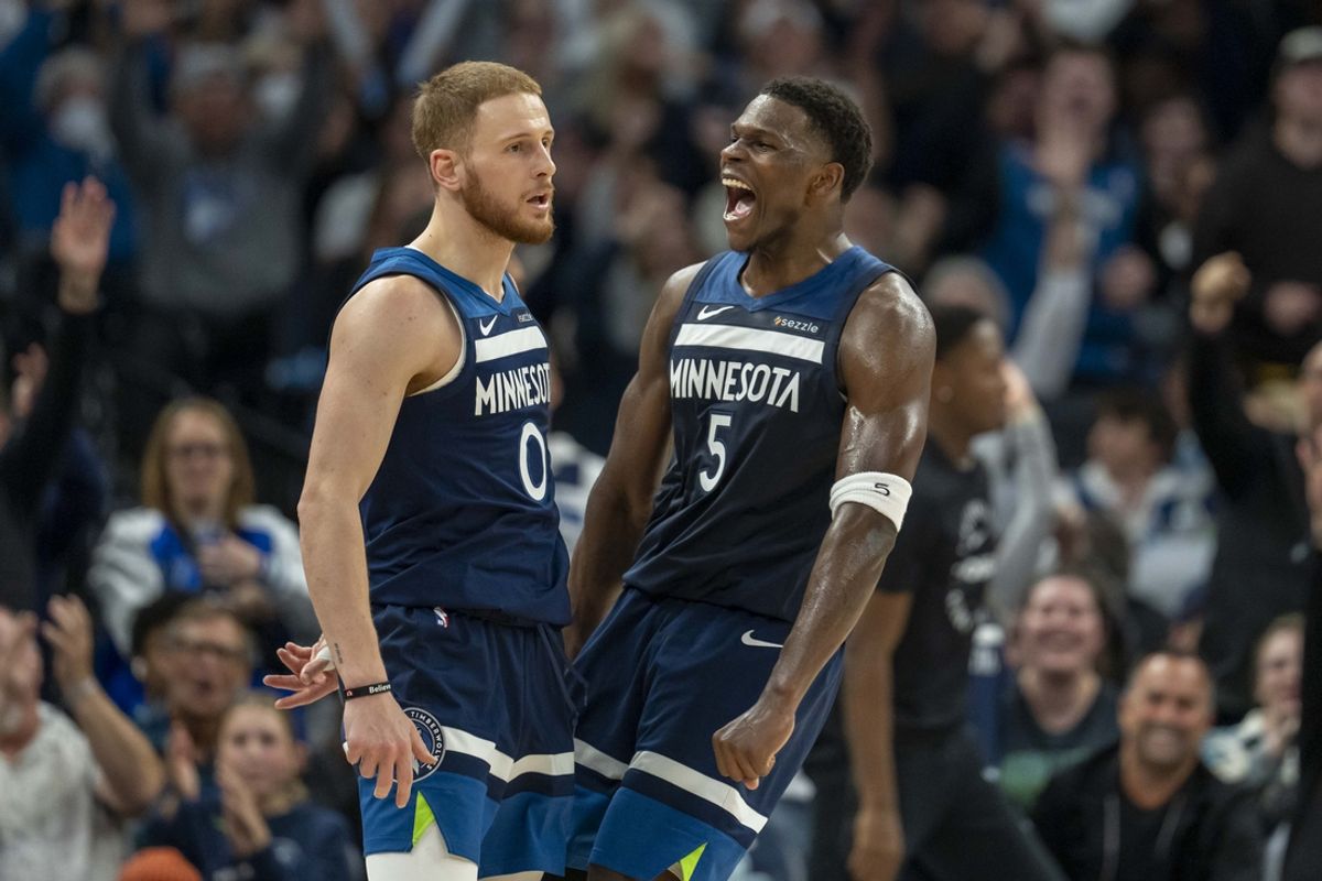 Nov 4, 2024; Minneapolis, Minnesota, USA; Minnesota Timberwolves guard Donte DiVincenzo (0) and Minnesota Timberwolves guard Anthony Edwards (5) celebrate after a shot is made against the Charlotte Hornets in the second half at Target Center. Mandatory Credit: Jesse Johnson-Imagn Images