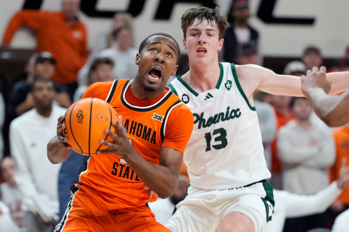 Oklahoma State Cowboys guard Bryce Thompson (1) puts up a shot beside Green Bay Phoenix forward Marcus Hall (13) during a college basketball game between the Oklahoma State Cowboys (OSU) and the Green Bay Phoenix at Gallagher-Iba Arena in Stillwater, Okla., Monday, Nov. 4, 2024.