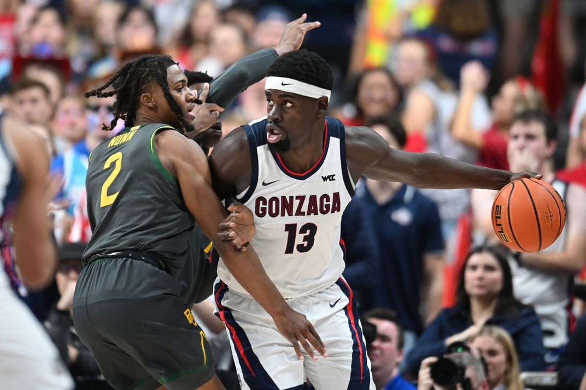 Nov 4, 2024; Spokane, Washington, USA; Gonzaga Bulldogs forward Graham Ike (13) controls the ball against Baylor Bears guard Jayden Nunn (2) in the first half at Spokane Arena. Mandatory Credit: James Snook-Imagn Images