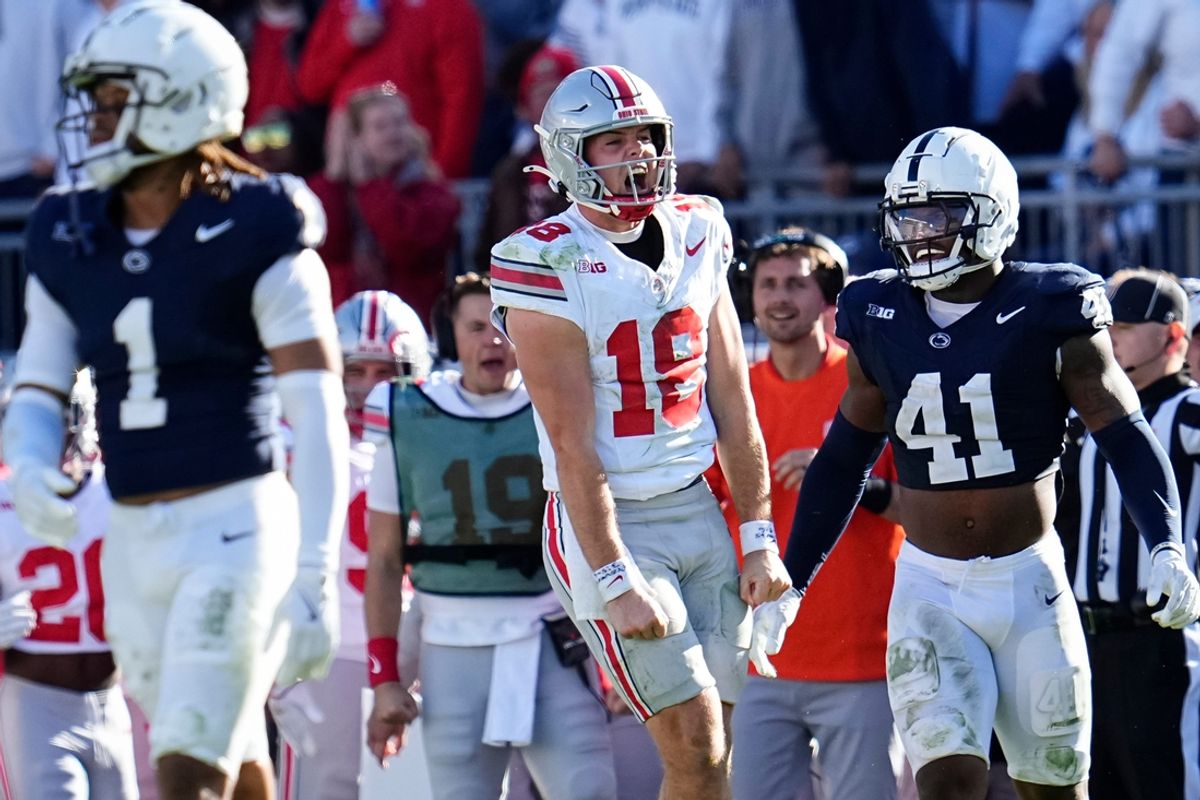 Ohio State Buckeyes quarterback Will Howard (18) celebrates a first down run beside Penn State Nittany Lions linebacker Kobe King (41) during the NCAA football game at Beaver Stadium in University Park, Pa. on Monday, Nov. 4, 2024. Ohio State won 20-13.