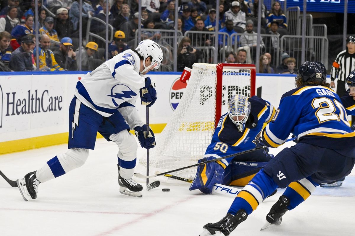 Nov 5, 2024; St. Louis, Missouri, USA;  St. Louis Blues goaltender Jordan Binnington (50) defends the net against Tampa Bay Lightning center Michael Eyssimont (23) during the second period at Enterprise Center. Mandatory Credit: Jeff Curry-Imagn Images