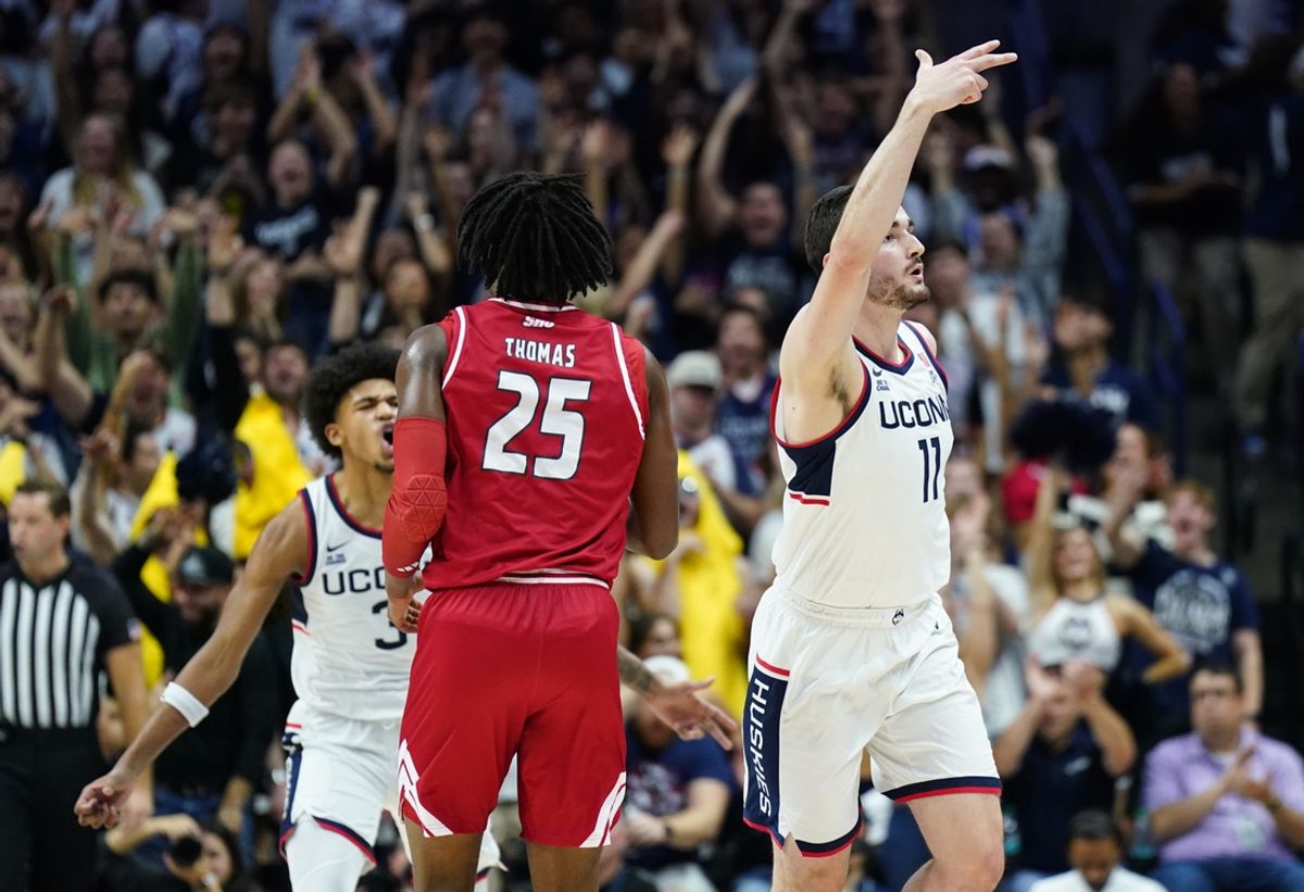 Nov 6, 2024; Storrs, Connecticut, USA; Connecticut Huskies forward Alex Karaban (11) reacts after his three point basket against Sacred Heart Pioneers forward Tanner Thomas (25) in the first half at Harry A. Gampel Pavilion. Mandatory Credit: David Butler II-Imagn Images
