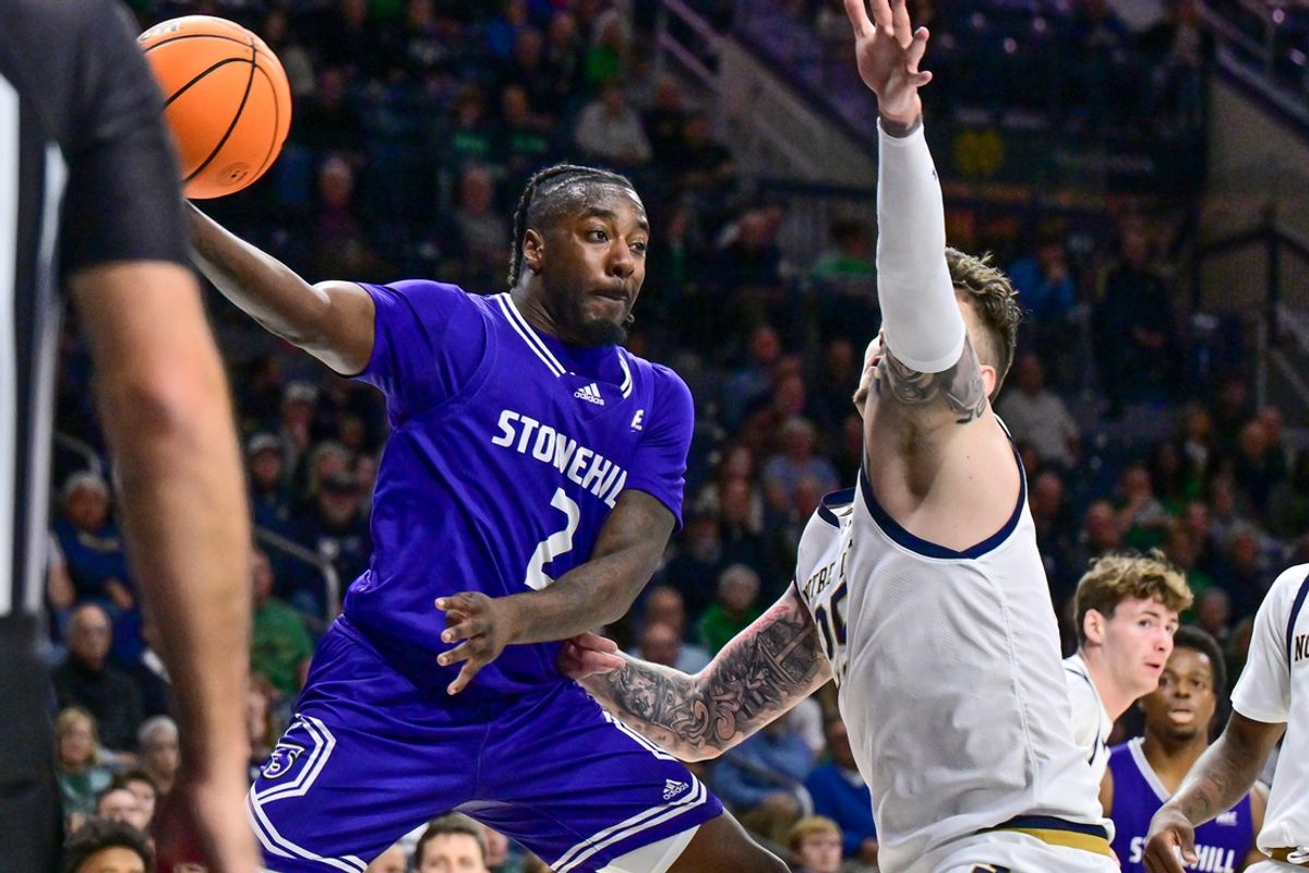 Nov 6, 2024; South Bend, Indiana, USA; Stonehill Skyhawks guard Amir Nesbitt (2) passes as Notre Dame Fighting Irish forward Nikita Konstantynovskyi (25) defends in the first half at the Purcell Pavilion. Mandatory Credit: Matt Cashore-Imagn Images