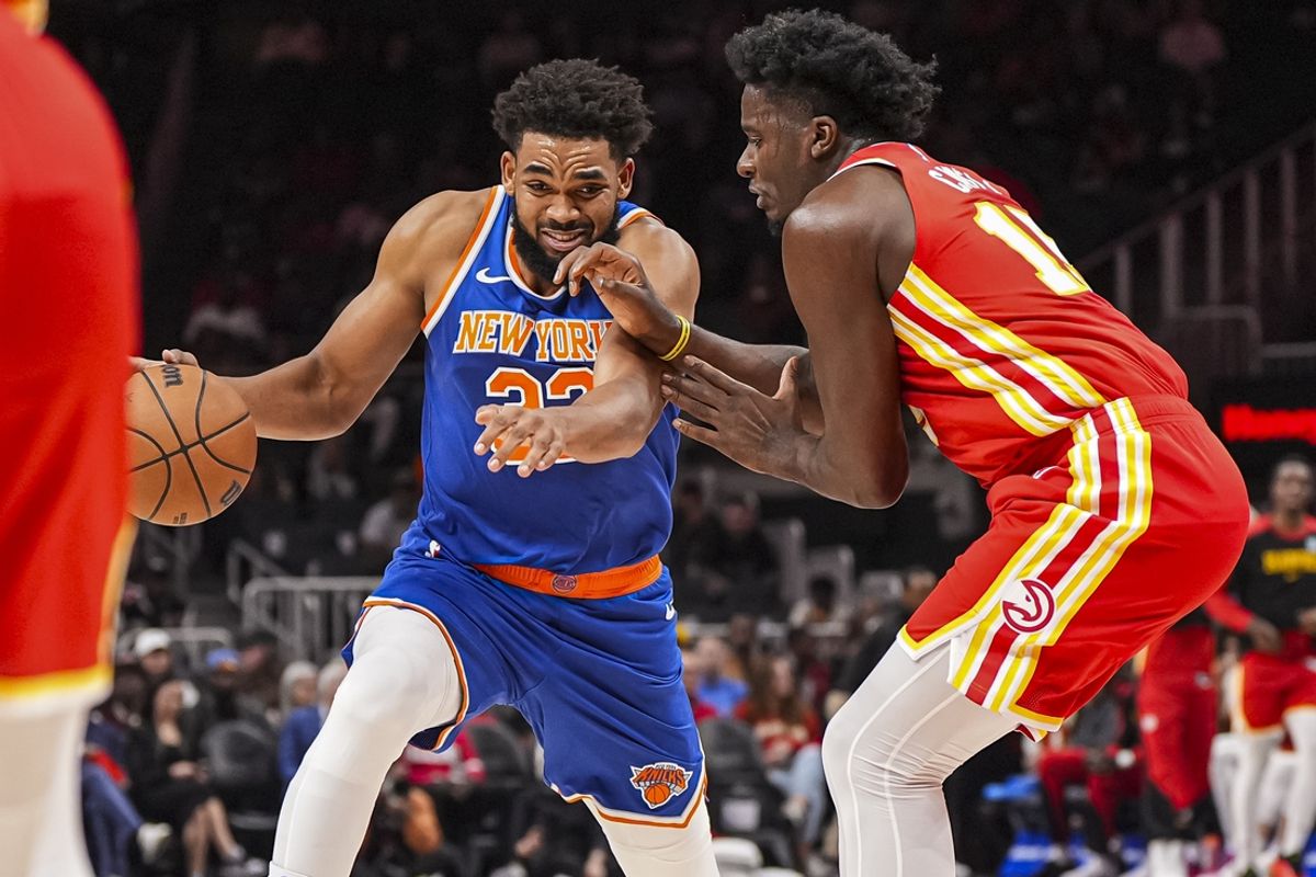 Nov 6, 2024; Atlanta, Georgia, USA; New York Knicks center Karl-Anthony Towns (32) tries to get to the basket past Atlanta Hawks center Clint Capela (15) during the first half at State Farm Arena. Mandatory Credit: Dale Zanine-Imagn Images