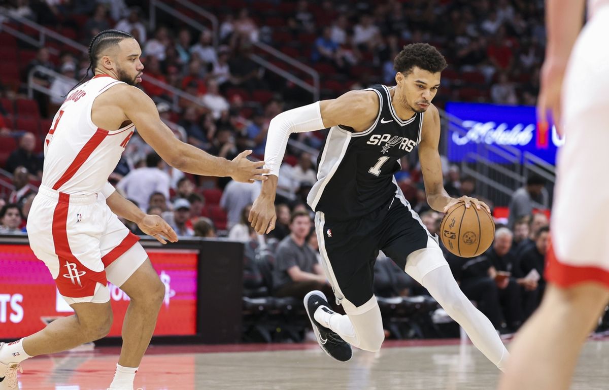 Nov 6, 2024; Houston, Texas, USA; San Antonio Spurs center Victor Wembanyama (1) drives with the ball as Houston Rockets forward Dillon Brooks (9) defends during the first quarter at Toyota Center. Mandatory Credit: Troy Taormina-Imagn Images