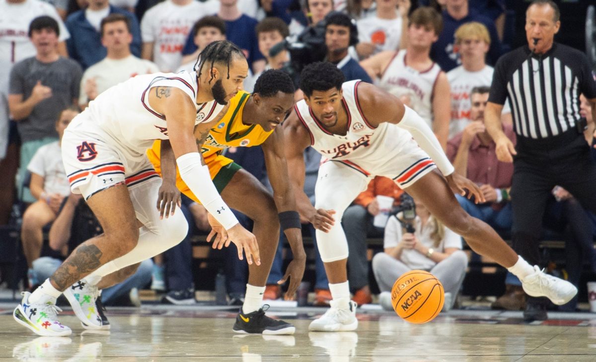 Auburn Tigers forward Johni Broome (4) and center Dylan Cardwell (44) fight Vermont Catamounts forward Ileri Ayo-Faleye (0) for a loose ball as Auburn Tigers take on Vermont Catamounts at Neville Arena in Auburn, Ala., on Wednesday, Nov. 6, 2024.
