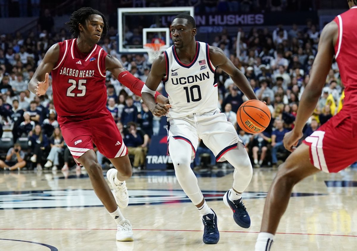 Nov 6, 2024; Storrs, Connecticut, USA; Connecticut Huskies guard Hassan Diarra (10) returns the ball against Sacred Heart Pioneers forward Tanner Thomas (25) in the second half at Harry A. Gampel Pavilion. Mandatory Credit: David Butler II-Imagn Images