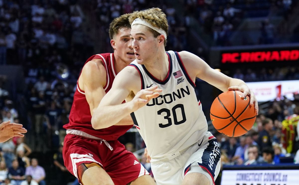 Nov 6, 2024; Storrs, Connecticut, USA; Connecticut Huskies forward Liam McNeeley (30) drives the ball against Sacred Heart Pioneers guard Griffin Barrouk (1) in the second half at Harry A. Gampel Pavilion. Mandatory Credit: David Butler II-Imagn Images