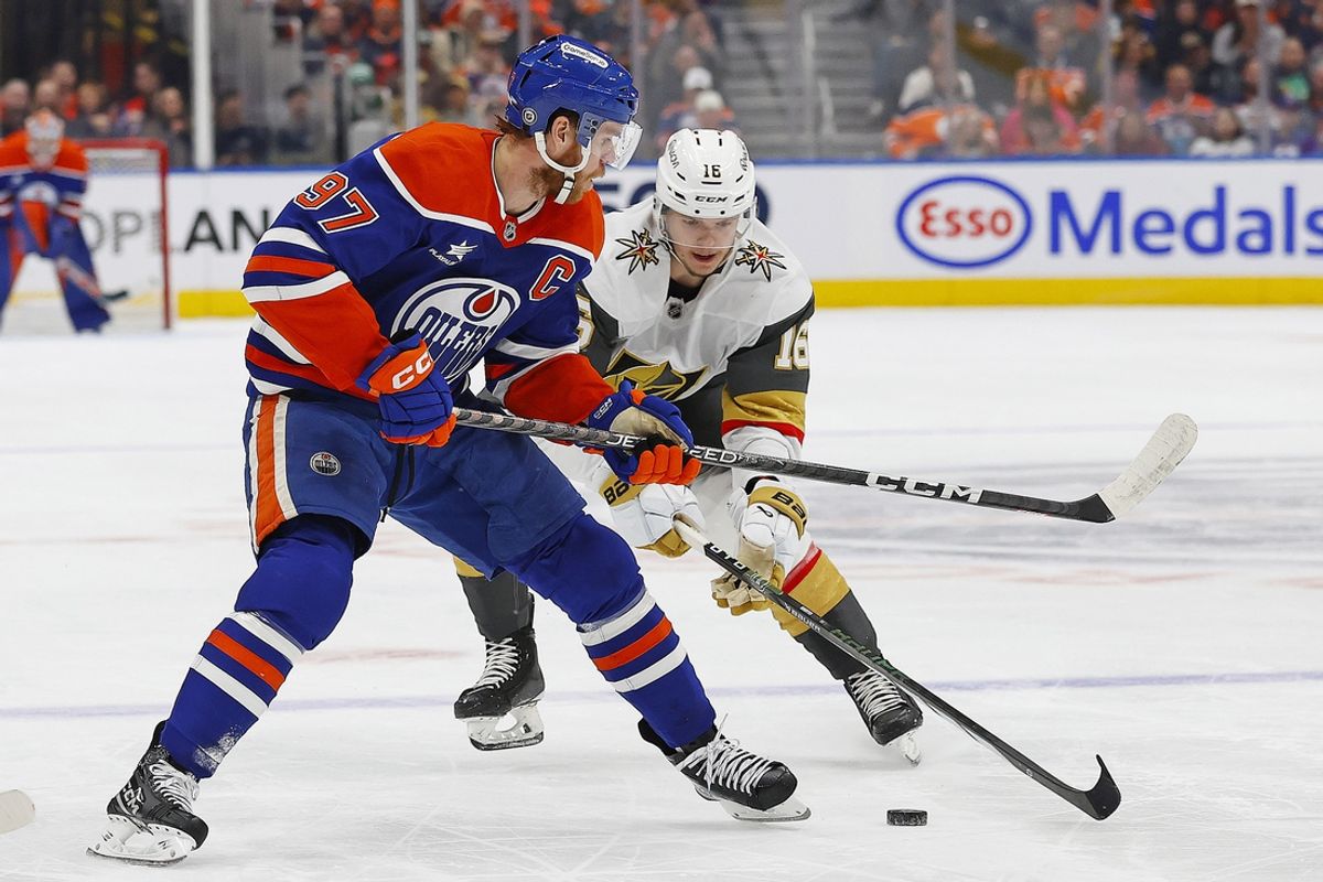 Nov 4, 2024; Edmonton, Alberta, CAN; Vegas Golden Knights forward Pavel Dorofeyev (16) tries to knock the puck away from Edmonton Oilers forward Connor McDavid (97) during the first period at Rogers Place. Mandatory Credit: Perry Nelson-Imagn Images