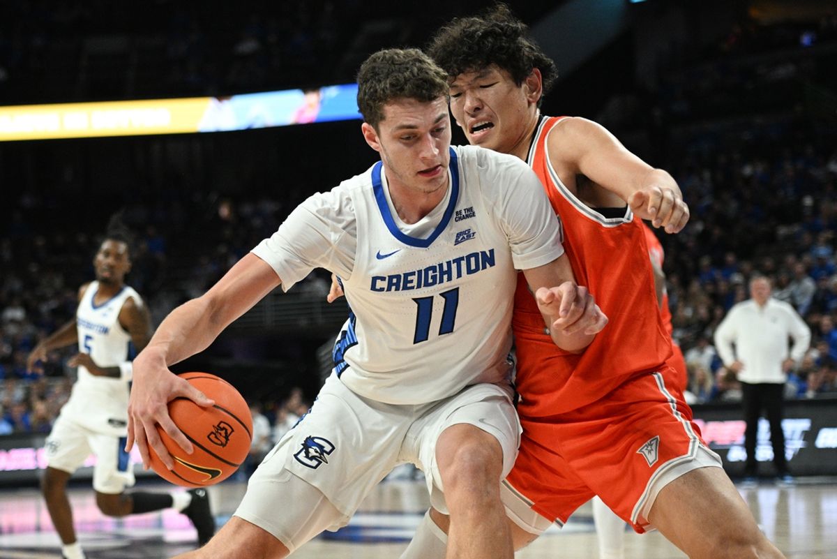 Nov 6, 2024; Omaha, Nebraska, USA;  Creighton Bluejays center Ryan Kalkbrenner (11) drives against UT Rio Grande Valley Vaqueros forward Tommy Gankhuyag (33) during the first half at CHI Health Center Omaha. Mandatory Credit: Steven Branscombe-Imagn Images