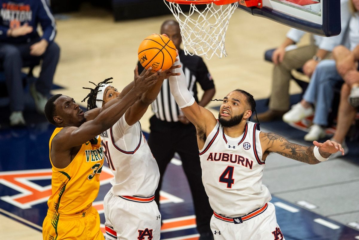 Vermont Catamounts forward Noah Barnett (34), Auburn Tigers forward Chaney Johnson (31) and forward Johni Broome (4) fight for a rebound as Auburn Tigers take on Vermont Catamounts at Neville Arena in Auburn, Ala., on Wednesday, Nov. 6, 2024. Auburn Tigers defeated Vermont Catamounts 94-43.