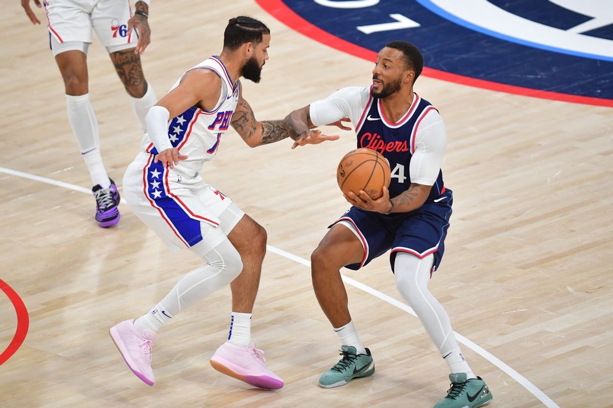 Nov 6, 2024; Inglewood, California, USA; Los Angeles Clippers guard Norman Powell (24) moves the ball against Philadelphia 76ers forward Caleb Martin (16) during the first half at Intuit Dome. Mandatory Credit: Gary A. Vasquez-Imagn Images