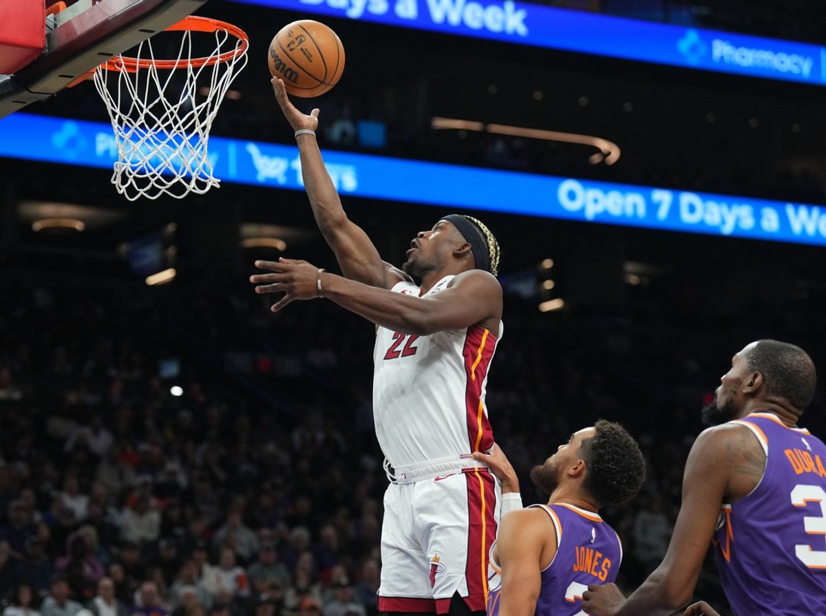 Nov 6, 2024; Phoenix, Arizona, USA; Miami Heat forward Jimmy Butler (22) puts up a layup against the Phoenix Suns during the second half at Footprint Center. Mandatory Credit: Joe Camporeale-Imagn Images