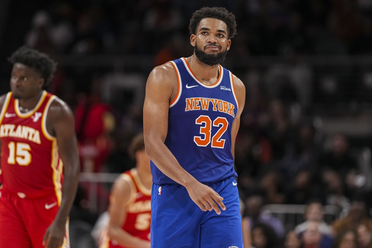 Nov 6, 2024; Atlanta, Georgia, USA; New York Knicks center Karl-Anthony Towns (32) reacts after making a three point shot against the Atlanta Hawks during the second half at State Farm Arena. Mandatory Credit: Dale Zanine-Imagn Images