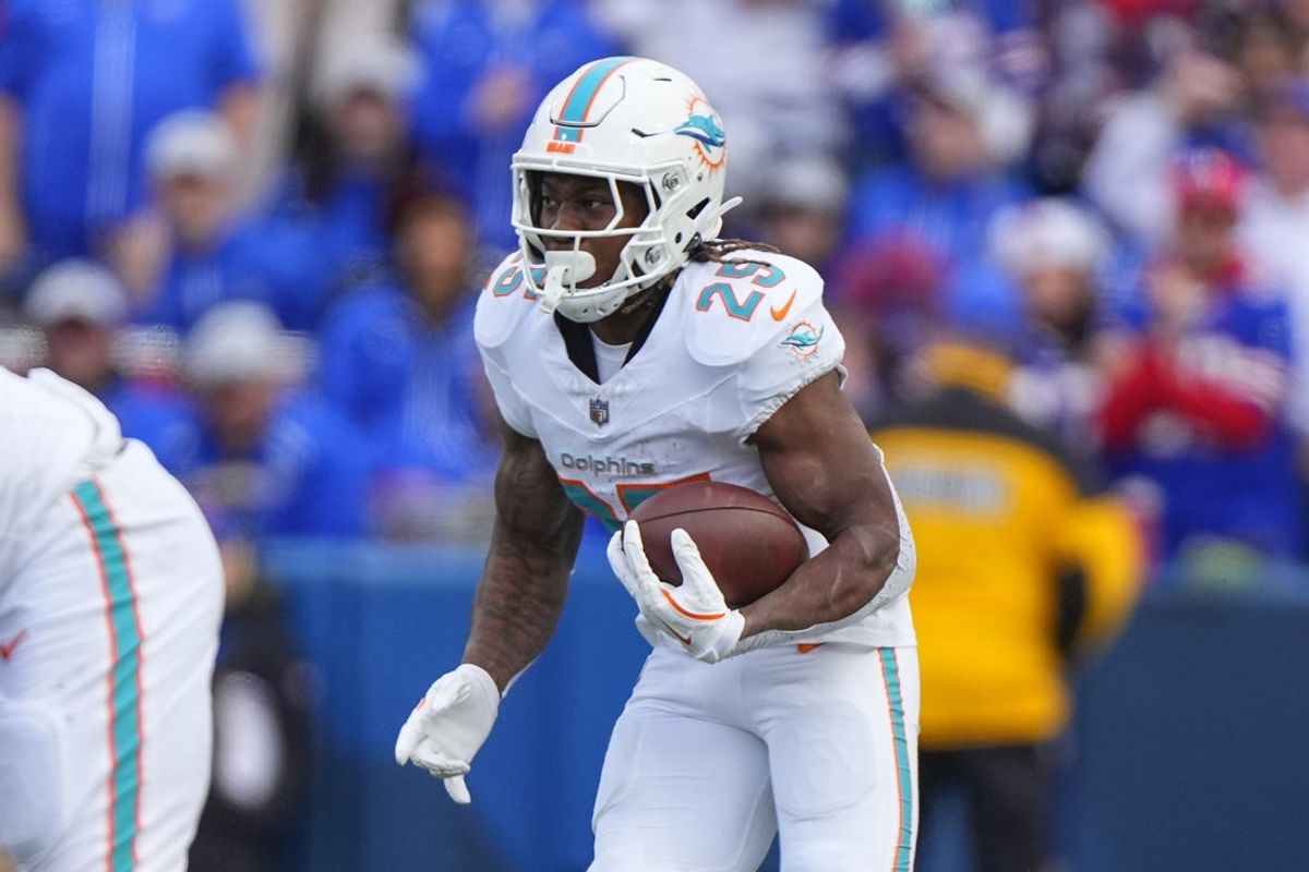 Nov 3, 2024; Orchard Park, New York, USA; Miami Dolphins running back Jaylen Wright (25) runs with the ball against the Buffalo Bills during the second half at Highmark Stadium. Mandatory Credit: Gregory Fisher-Imagn Images
