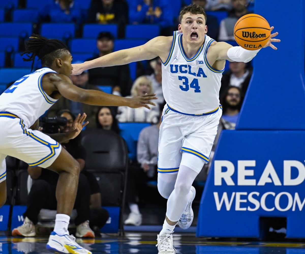 Nov 4, 2024; Los Angeles, California, USA; UCLA Bruins forward Tyler Bilodeau (34) chases after a loose ball during the first half against the Rider Broncs at Pauley Pavilion presented by Wescom. At left is UCLA Bruins guard Dylan Andrews (2). Mandatory Credit: Robert Hanashiro-Imagn Images