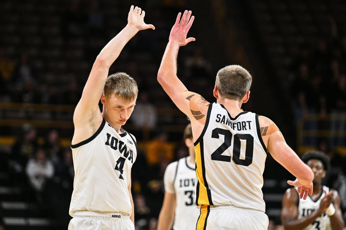 Nov 7, 2024; Iowa City, Iowa, USA; Iowa Hawkeyes guard Josh Dix (4) reacts with forward Payton Sandfort (20) during the first half against the Southern University Jaguars at Carver-Hawkeye Arena. Mandatory Credit: Jeffrey Becker-Imagn Images
