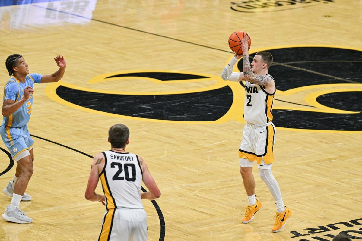 Nov 7, 2024; Iowa City, Iowa, USA; Iowa Hawkeyes guard Drew Thelwell (3) shoots a three point basket as Southern University Jaguars guard Cam Amboree (3) defends during the second half at Carver-Hawkeye Arena. Mandatory Credit: Jeffrey Becker-Imagn Images