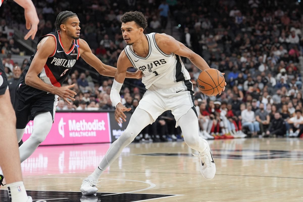 Nov 7, 2024; San Antonio, Texas, USA;  San Antonio Spurs center Victor Wembanyama (1) dribbles against Portland Trail Blazers guard Rayan Rupert (21) in the first half at Frost Bank Center. Mandatory Credit: Daniel Dunn-Imagn Images