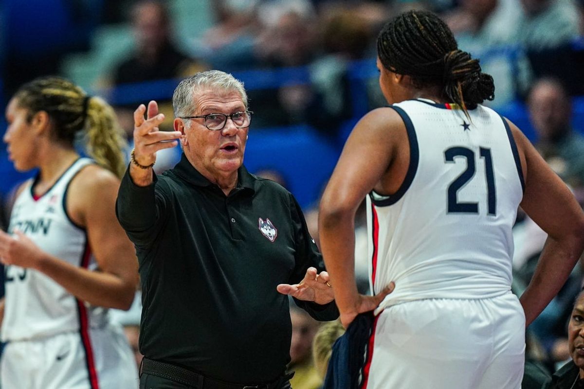 Nov 7, 2024; Storrs, Connecticut, USA; UConn Huskies head coach Geno Auriemma talks with forward Sarah Strong (21) from the sideline as they take on the Boston University Terriers at Harry A. Gampel Pavilion. Mandatory Credit: David Butler II-Imagn Images