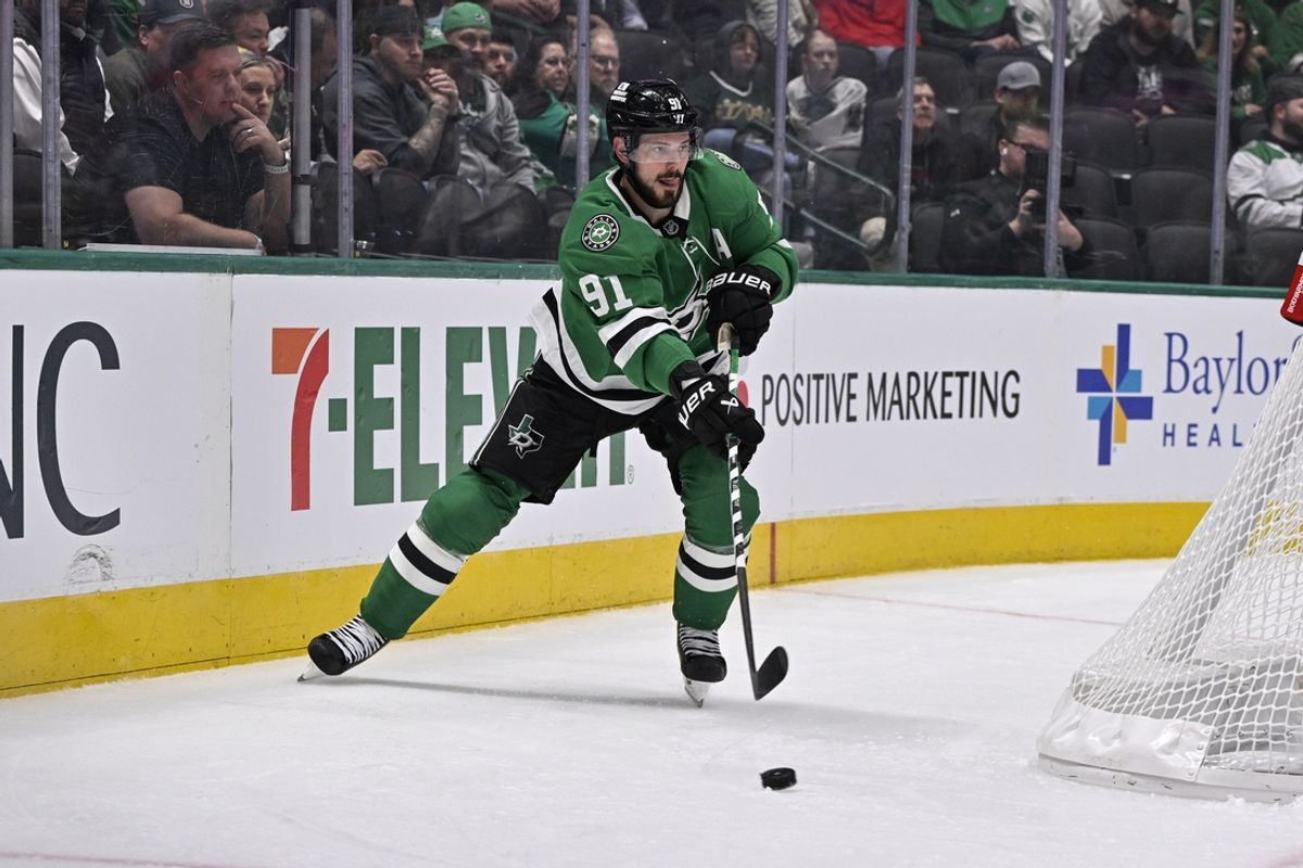 Nov 7, 2024; Dallas, Texas, USA; Dallas Stars center Tyler Seguin (91) passes the puck against the Chicago Blackhawks during the second period at the American Airlines Center. Mandatory Credit: Jerome Miron-Imagn Images