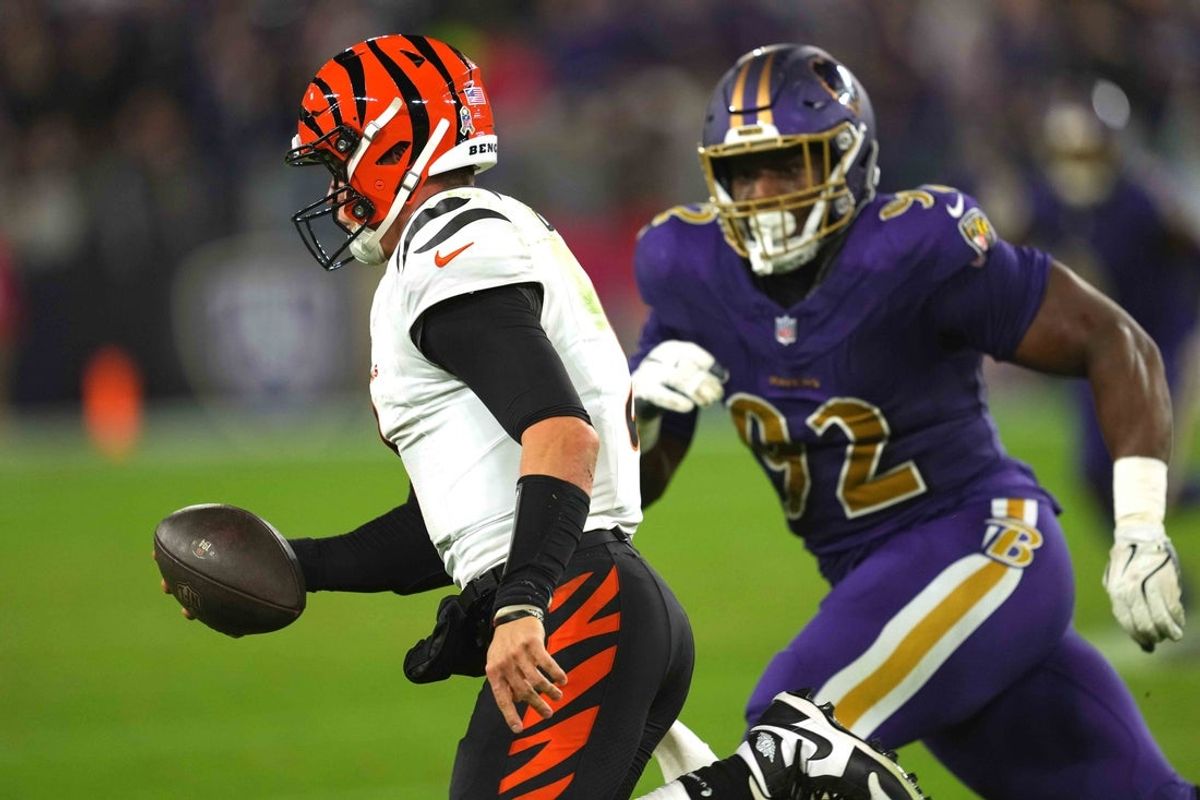 Nov 7, 2024; Baltimore, Maryland, USA; Cincinnati Bengals quarterback Joe Burrow (9) pressured by Baltimore Ravens  Nnamdi Madubuike (92) during the second quarter at M&T Bank Stadium. Mandatory Credit: Mitch Stringer-Imagn Images