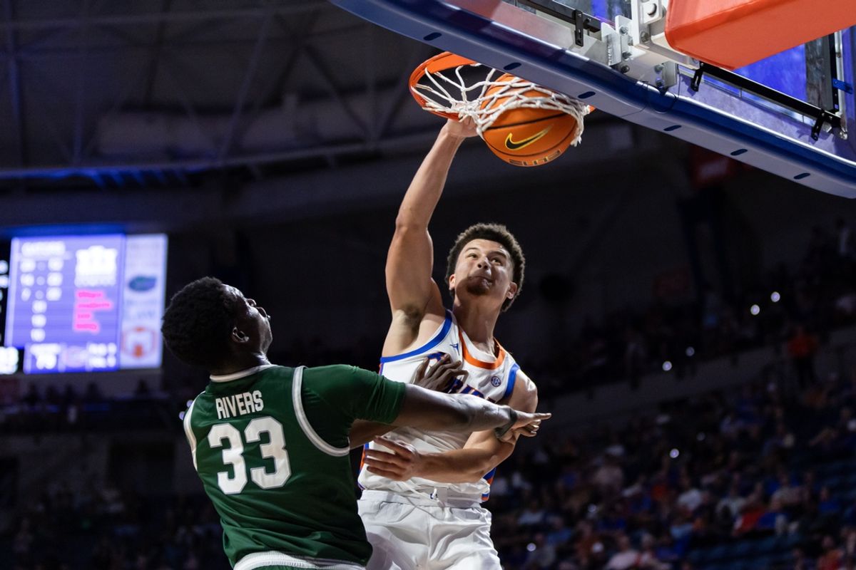 Nov 7, 2024; Gainesville, Florida, USA; Florida Gators guard Walter Clayton Jr. (1) dunks against Jacksonville Dolphins forward Donovan Rivers (33) during the second half at Exactech Arena at the Stephen C. O'Connell Center. Mandatory Credit: Matt Pendleton-Imagn Images