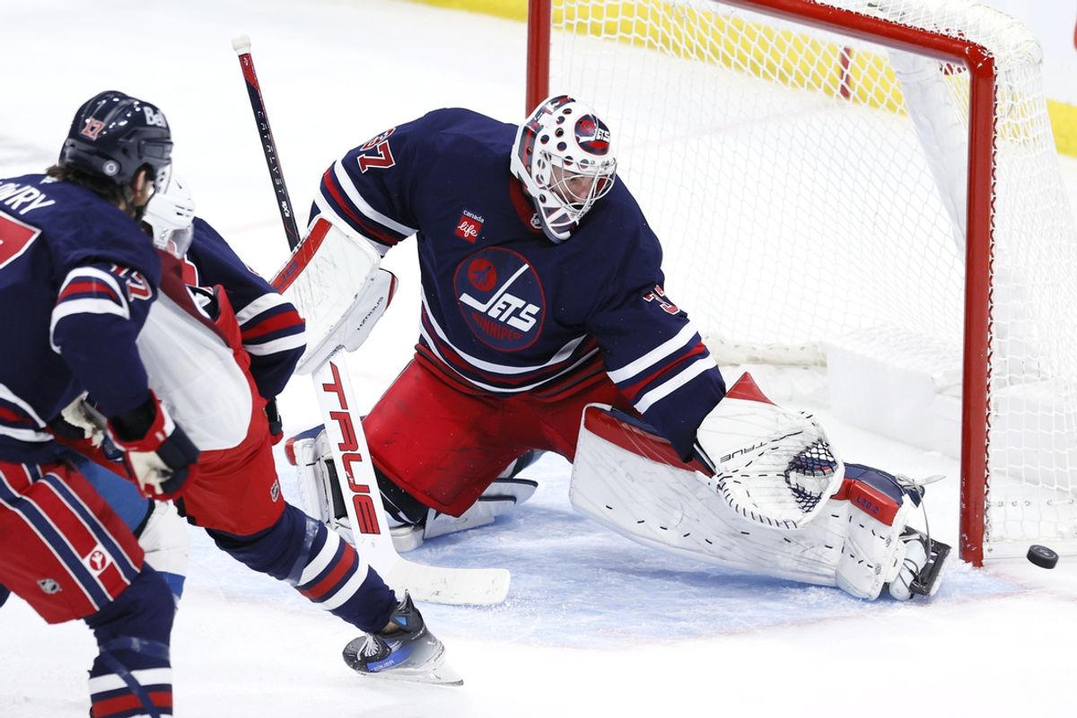Nov 7, 2024; Winnipeg, Manitoba, CAN; Winnipeg Jets goaltender Connor Hellebuyck (37) makes a pad save in the third period against the Colorado Avalanche at Canada Life Centre. Mandatory Credit: James Carey Lauder-Imagn Images