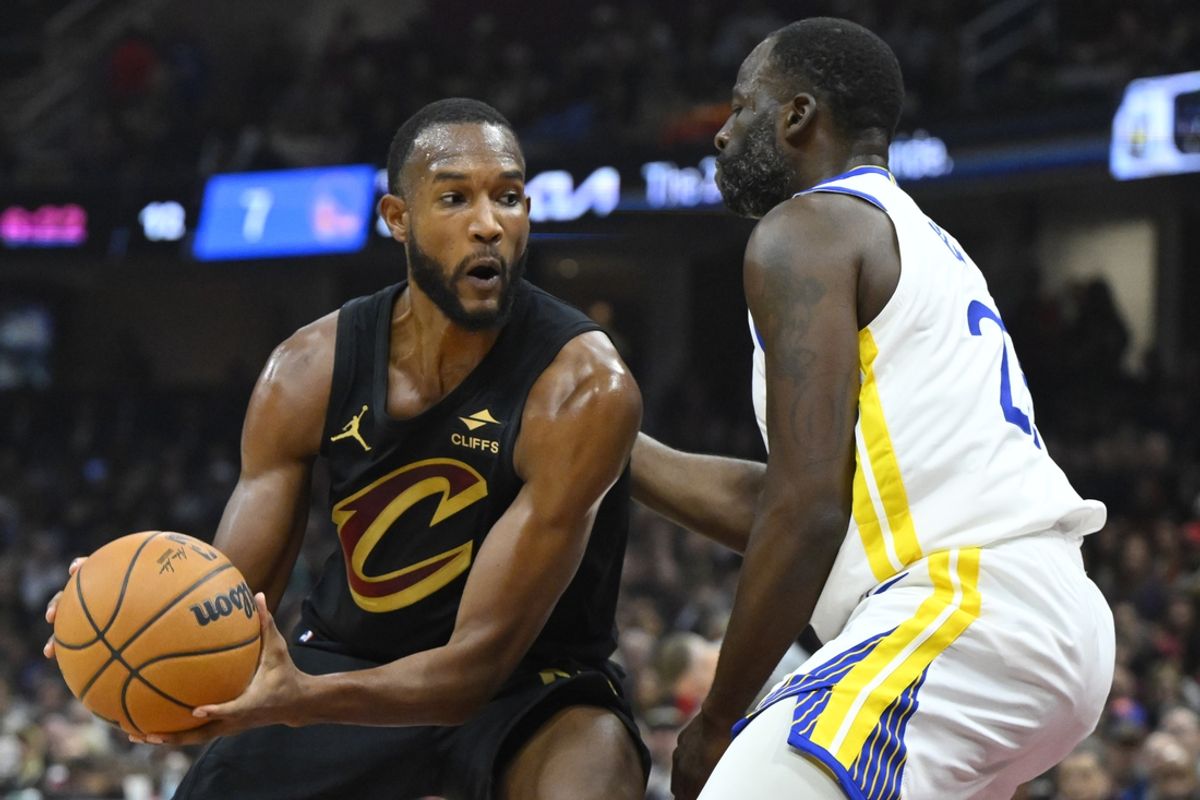 Nov 8, 2024; Cleveland, Ohio, USA; Golden State Warriors forward Draymond Green (23) defends Cleveland Cavaliers forward Evan Mobley (4) in the first quarter at Rocket Mortgage FieldHouse. Mandatory Credit: David Richard-Imagn Images