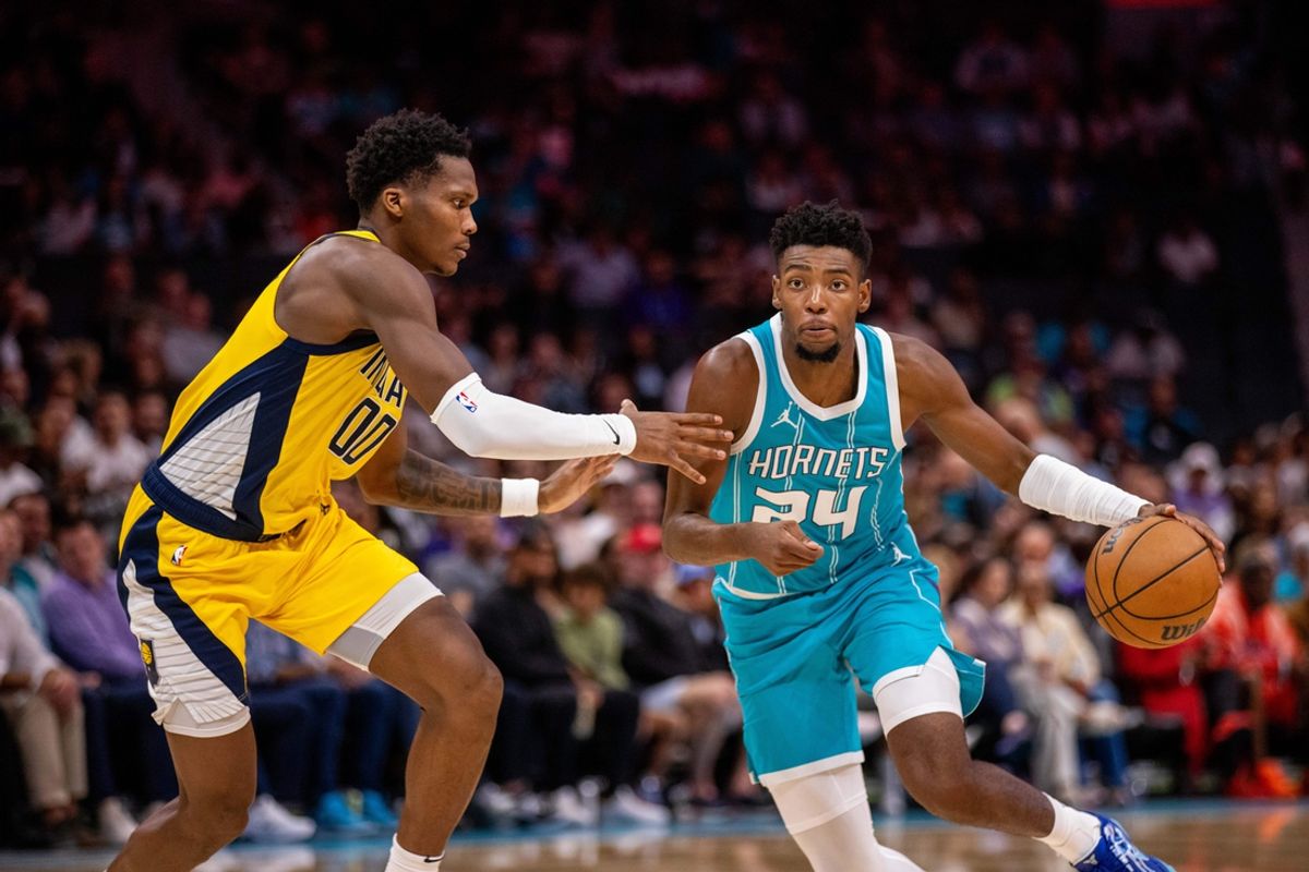 Nov 8, 2024; Charlotte, North Carolina, USA; Charlotte Hornets forward Brandon Miller (24) drives against Indiana Pacers guard Bennedict Mathurin (00) during the second quarter at Spectrum Center. Mandatory Credit: Scott Kinser-Imagn Images
