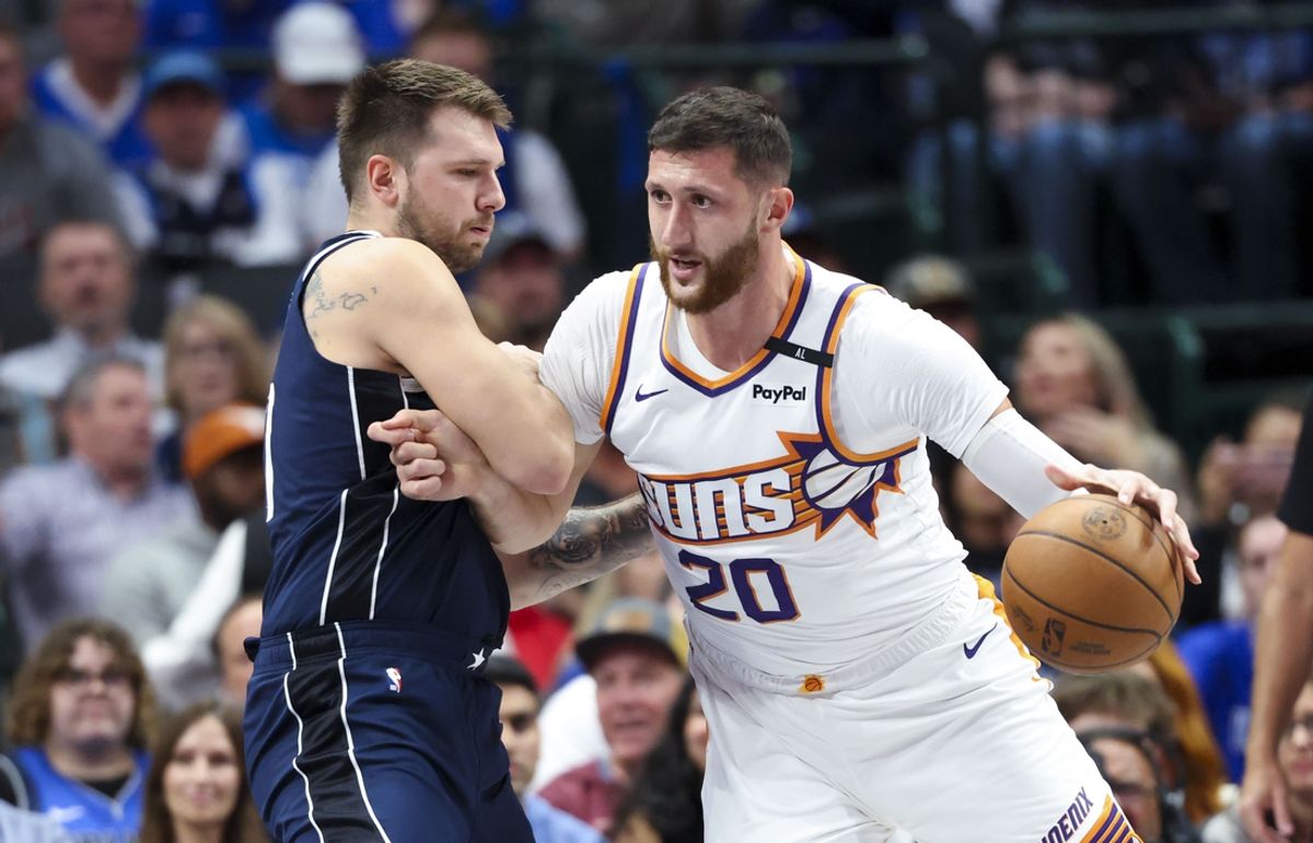 Nov 8, 2024; Dallas, Texas, USA;  Phoenix Suns center Jusuf Nurkic (20) dribbles as Dallas Mavericks guard Luka Doncic (77) defends during the first quarter at American Airlines Center. Mandatory Credit: Kevin Jairaj-Imagn Images