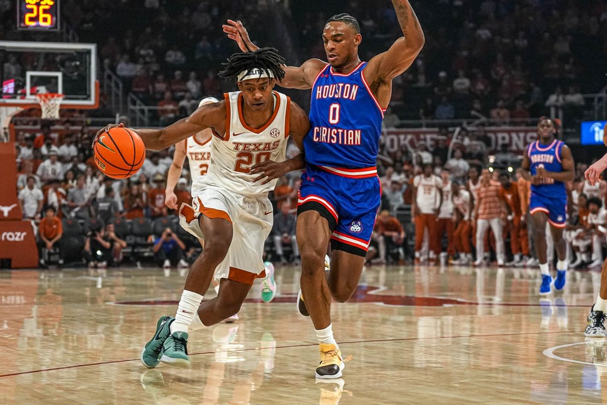 Texas Longhorns guard Tre Johnson (20) pushes past Houston Christian guard Demari Williams (0) during the game at the Moody Center on Friday, Nov. 8, 2024 in Austin.