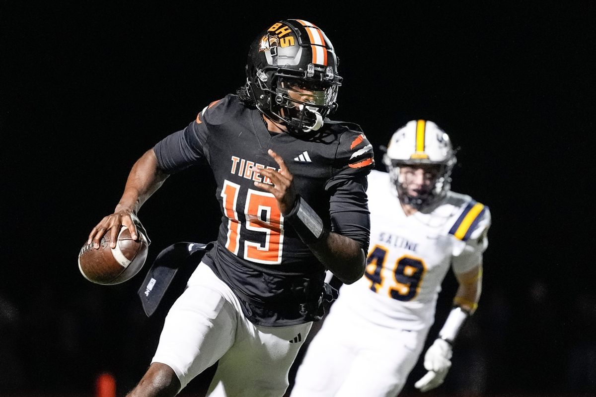 Belleville quarterback Bryce Underwood keeps the ball and runs against Saline during the second half of district final at Belleville High School in Belleville on Friday, Nov. 8, 2024.