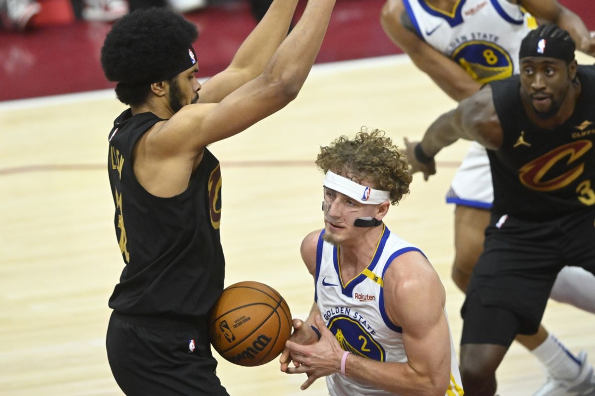 Nov 8, 2024; Cleveland, Ohio, USA; Golden State Warriors guard Brandin Podziemski (2) loses the ball against Cleveland Cavaliers center Jarrett Allen (31) in the fourth quarter at Rocket Mortgage FieldHouse. Mandatory Credit: David Richard-Imagn Images