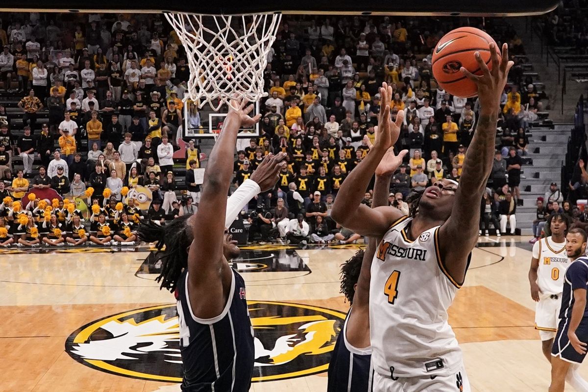 Nov 8, 2024; Columbia, Missouri, USA; Missouri Tigers guard Marcus Allen (4) shoots a layup as Howard Bison guard Bryce Harris (34) defends during the second half at Mizzou Arena. Mandatory Credit: Denny Medley-Imagn Images