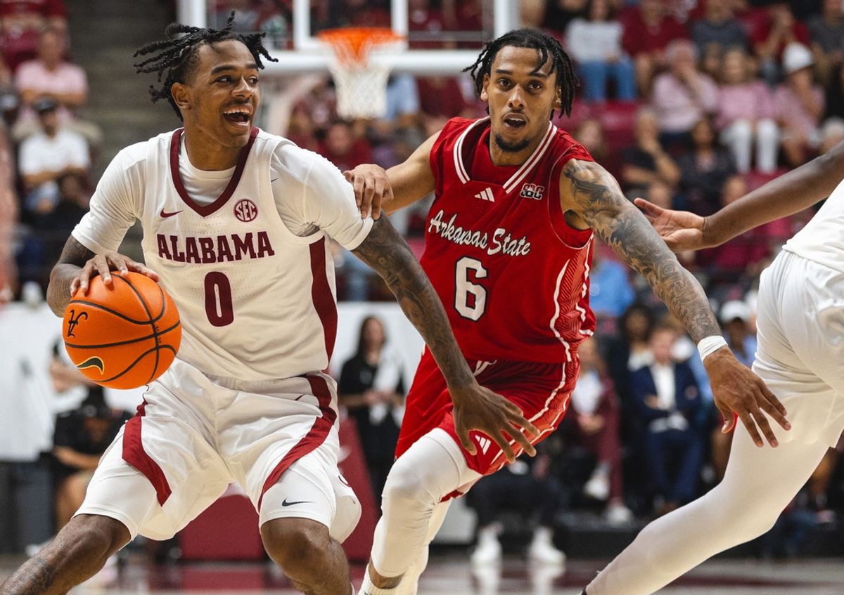 Nov 8, 2024; Tuscaloosa, Alabama, USA; Alabama Crimson Tide guard Labaron Philon (0) drives against Arkansas State Red Wolves guard Taryn Todd (6) during the second half at Coleman Coliseum. Mandatory Credit: Will McLelland-Imagn Images