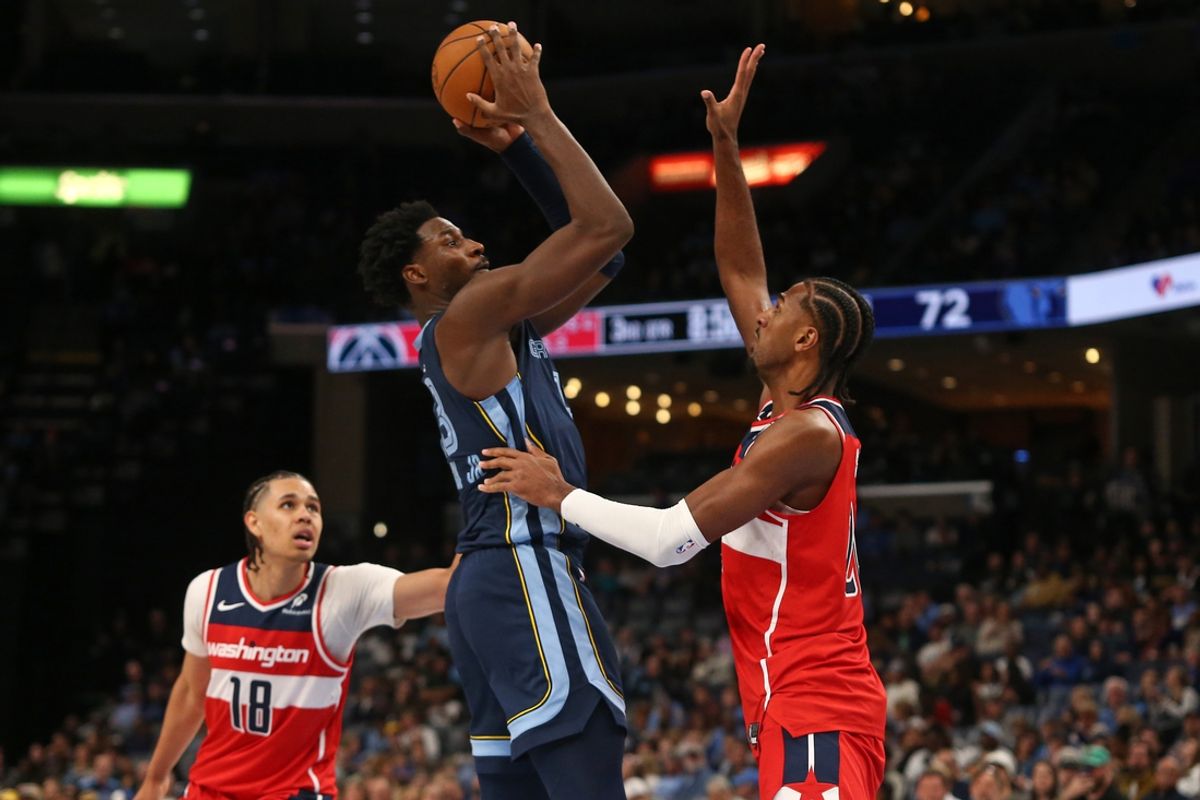 Nov 8, 2024; Memphis, Tennessee, USA; Memphis Grizzlies forward Jaren Jackson Jr. (13) shoots against Washington Wizards forward Alexandre Sarr (20) during the second half at FedExForum. Mandatory Credit: Petre Thomas-Imagn Images