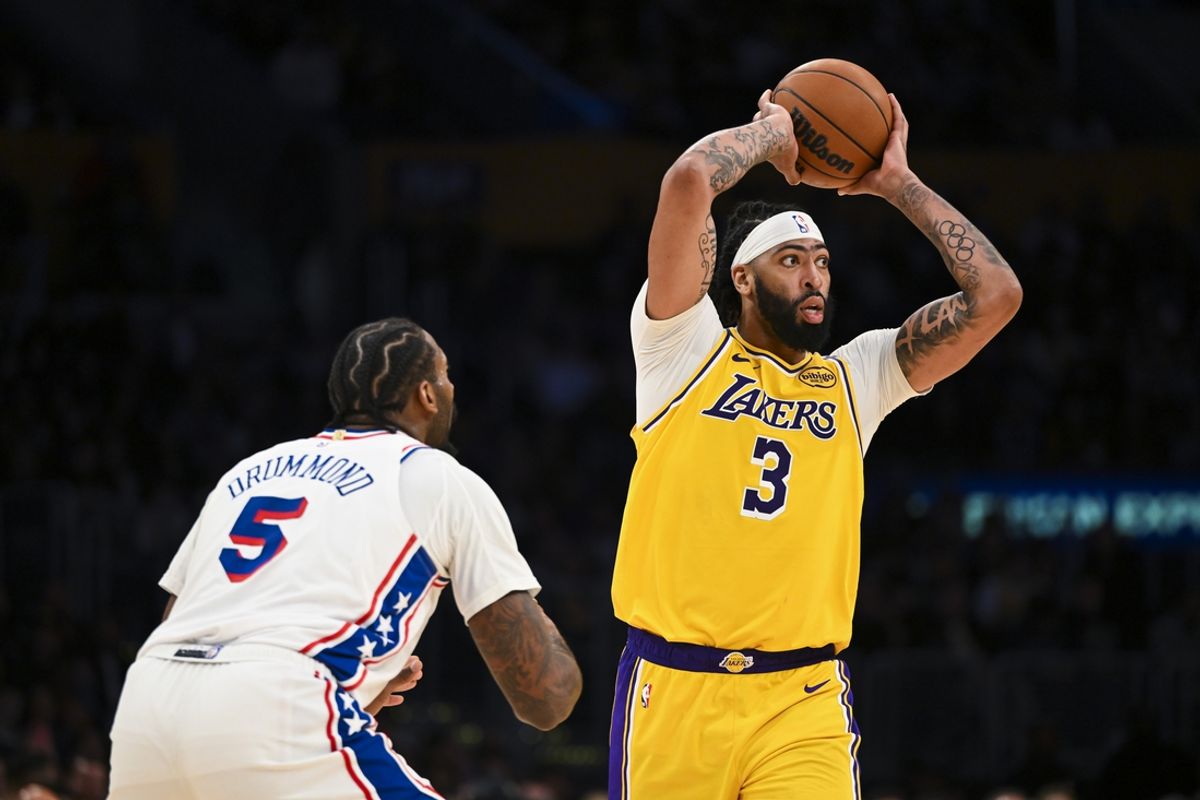 Nov 8, 2024; Los Angeles, California, USA; Los Angeles Lakers forward Anthony Davis (3) looks to pass against Philadelphia 76ers center Andre Drummond (5) during the second half at Crypto.com Arena. Mandatory Credit: Jonathan Hui-Imagn Images