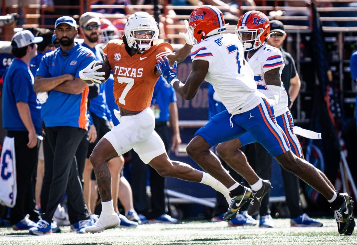 Texas Longhorns wide receiver Isaiah Bond (7) puts out an arm to stop a tackle from Florida Gators defensive back Trikweze Bridges (7) during the first quarter of the Longhorns' game against the Florida Gators, Nov. 9, 2024 at Darrell K. Royal Texas Memorial Stadium in Austin.